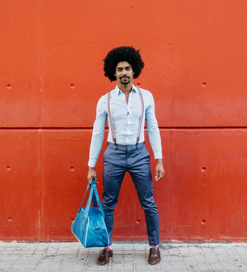 portrait-of-fashionable-man-with-bag-standing-in-f-2022-03-08-01-26-29-utc.jpg